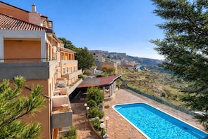 A residential building with a swimming pool, outdoor seating, and a view of a hillside. - B&B with Window - 236 - Santangelo - Pool (Monte Sant'Angelo)