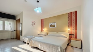 A double bed with a quilted bedspread, a bedside table, a nightstand, a wall-mounted picture, and a window with curtains. - B&B with Window - 236 - Santangelo - Pool (Monte Sant'Angelo)