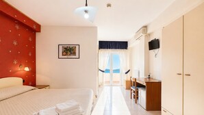 A bedroom with a bed, a desk, and a view of the outdoors. - B&B Sea View with Balcony - 243- Santangelo - Pool (Monte Sant'Angelo)