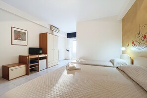 A hotel room with a bed, a desk, a television, and a window. - Bright B&B with Sea View Balcony - 242- Santangelo - Pool (Monte Sant'Angelo)