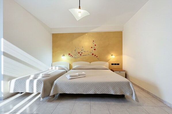 A modern hotel room with a large bed, two bedside tables, a wall-mounted artwork, and a ceiling light fixture. - Bright B&B with Sea View Balcony - 242- Santangelo - Pool (Monte Sant'Angelo)