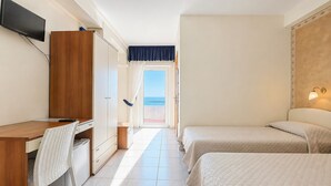 A hotel room with a desk, chair, two beds, a TV, and a view of the sea. - Bright B&B with Sea View Balcony - 244 - Santangelo - Pool (Monte Sant'Angelo)