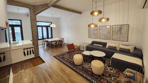 A modern living room with a sofa, rug, and pendant lights. - Spacious 4BR· Families & Groups · Central Apartment · Recoleta (Buenos Aires)
