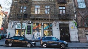 A multi-story building with a classic architectural style, featuring balconies and large windows. - Spicy Hostel (Budapest)