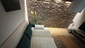 A modern living room with a sofa, a small table, and a TV stand. - Vacation home Haus zur Böhme (gateway to the Thuringian Forest) (Georgenthal)