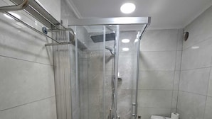 A bathroom with a glass-enclosed shower, a toilet, and a sink. - Zeynus Hotel Kadıköy (İstanbul)