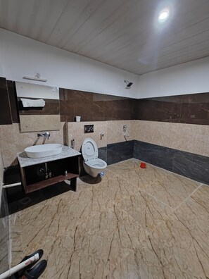 A bathroom with a marble floor, a sink, a toilet, and a shower. - Indus Serenity Retreat, Ladakh (Leh)
