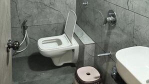 A bathroom with a toilet, bidet, and sink. - Hotel 7 CR (Ahmedabad)