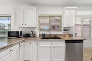 Full kitchen with stainless appliances and granite
