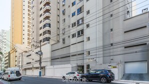 A multi-story building with balconies, a sign reading "ATHAYDE," and parked cars on the street. - Apt in Downtown BC 350m From the Beach Pae1002 (Balneário Camboriú)