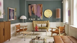 A living room with a sofa, chairs, a coffee table, and a fireplace. - The Darling (Copenhagen)