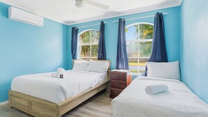 A hotel room with two beds, a wooden headboard, a nightstand, and a window with curtains. - Boater's Retreat - pet friendly, right off the M1 (Boambee East)