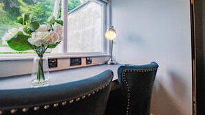 A room with a window, a desk, a chair, and a lamp. - Modern Studio by Howth Marina (Howth)