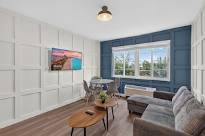 Elite Apartment, Garden View | Living area | 50-inch Smart TV with digital channels