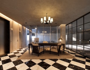 A modern dining area with a checkered floor, a chandelier, and a view through large windows. - Trobbu Boutique Collection San Miguel de Allende - All Inclusive (San Miguel de Allende)