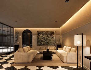 Un salon moderne avec un sol à carreaux, deux canapés, une table basse et un grand tableau abstrait accroché au mur.
