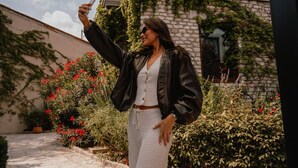 A person taking a selfie in an outdoor setting with a stone building and greenery in the background. - Trobbu Boutique Collection San Miguel de Allende - All Inclusive (San Miguel de Allende)