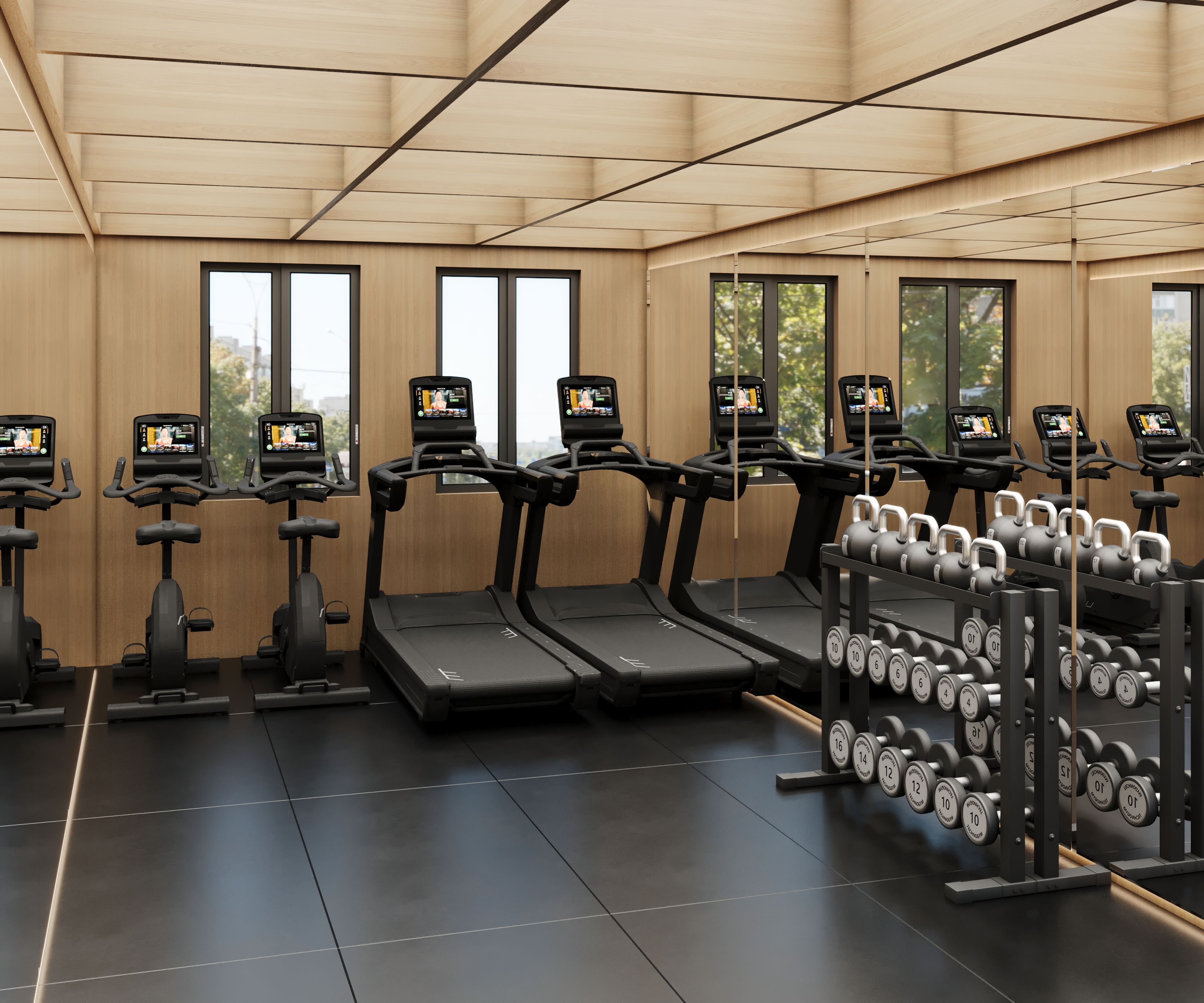 Une salle de sport équipée de tapis de course, d’haltères et d’appareils d’entraînement.
