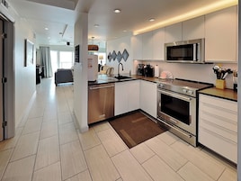 A modern kitchen with stainless steel appliances, a microwave, and a coffee maker.
