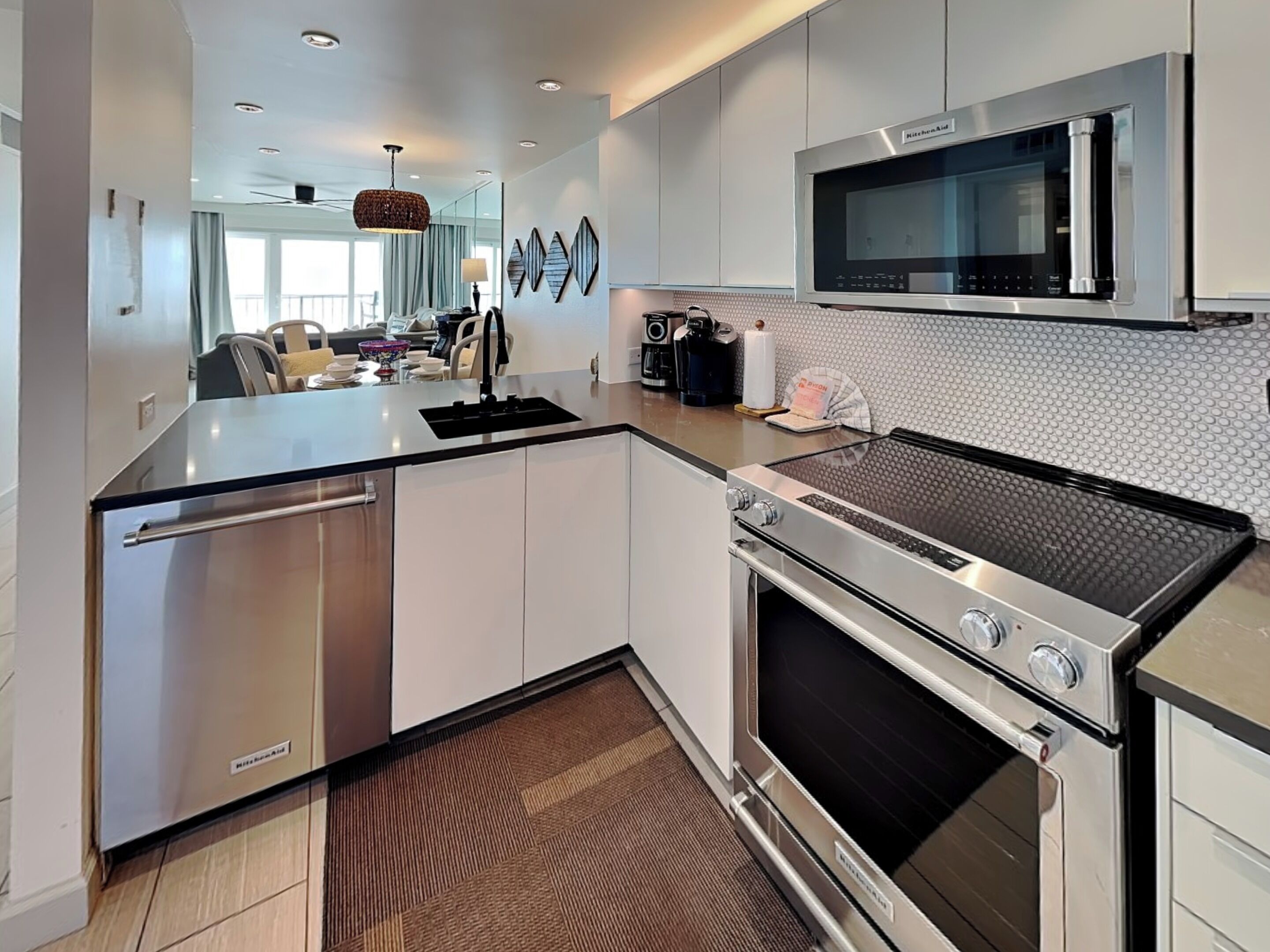 A modern kitchen with stainless steel appliances, a built-in microwave, and a large island with seating.