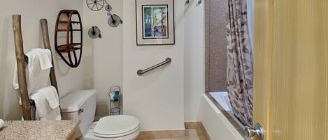 A bathroom with a toilet, sink, and bathtub.