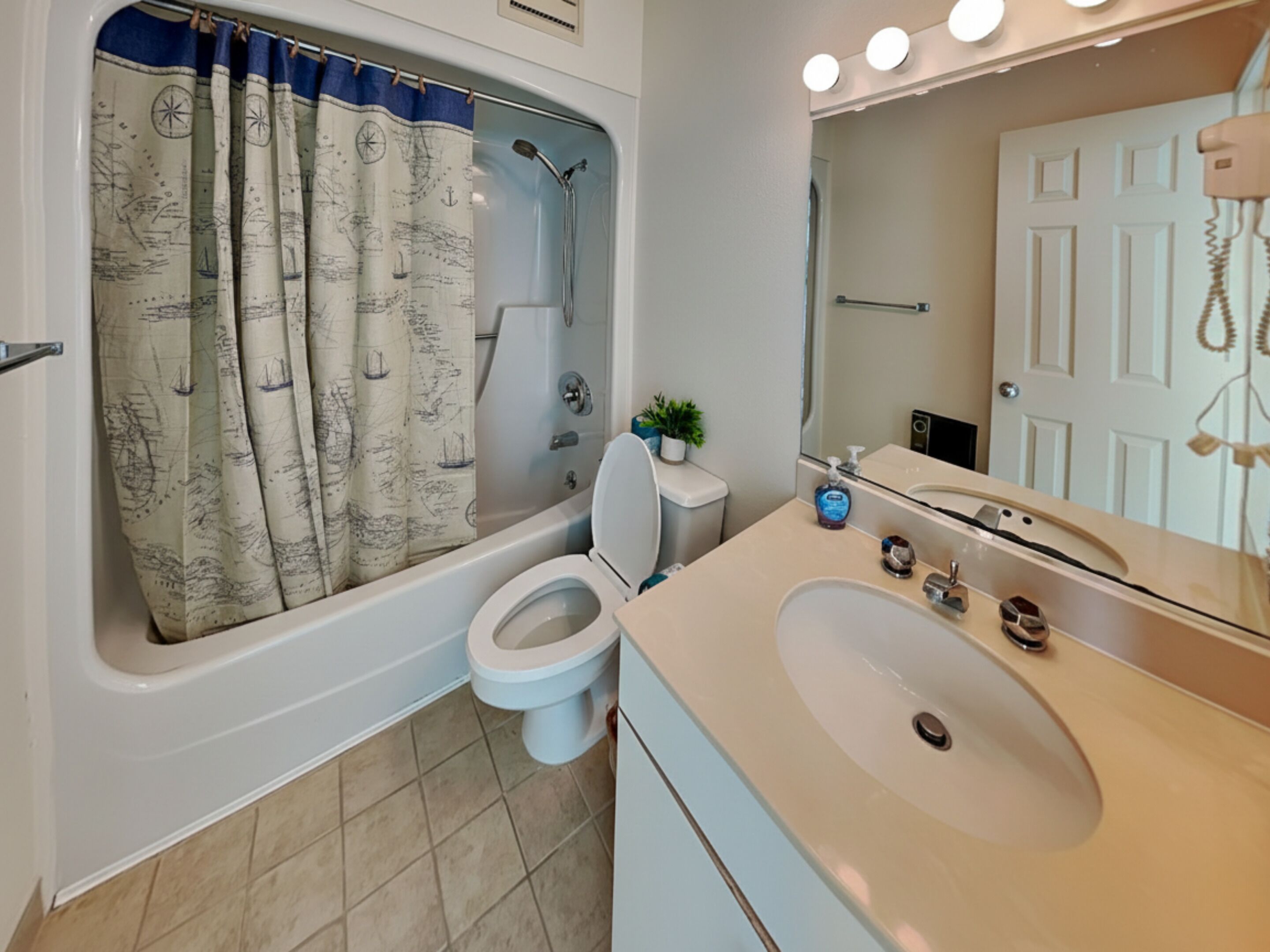 A bathroom with a bathtub, toilet, and sink.
