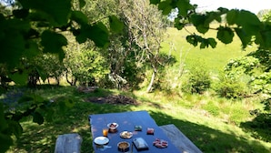 A picnic table set up outdoors with various food items and drinks. - Bryn Y Garreg Cottage - The Wireless Free Farm (Welshpool)
