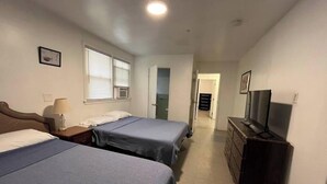 A hotel room with two beds, a dresser, a television, and a window with blinds. - “The Retreat” with two balconies free parking (Atlantic City)