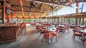 A spacious restaurant with high ceilings, exposed beams, and large windows offering views of the outdoors. - Escape to Abbey Springs! 2 bedroom, 1 Bath Condo in Private Gated Community (Fontana-on-Geneva Lake)