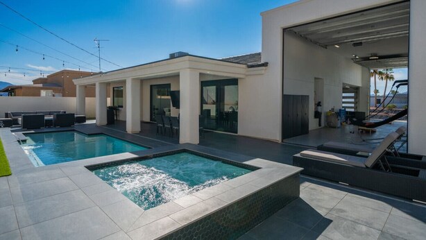 A modern house with a swimming pool, outdoor seating, and a covered garage. - Havasu Hideaway: Modern Lux, Pool+Spa, Near Marina (Lake Havasu City)