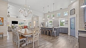 A spacious kitchen with a central island, wooden flooring, and pendant lighting. - Resort Feel Home, Private Pool,spa,hammocks. Beach,owa,wharf-15min, 5 Bedrooms (Foley)
