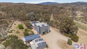 A building with a grey roof, surrounded by trees and a clear sky. - The Castle: Off-Grid Retreat nestled in the Sedgwick Valley 20 mins from Bendigo (Sedgwick)