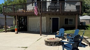 A two-story house with a balcony, a garage, and outdoor seating. - Beach House w/ Huge Deck Amazing Views!! Kayaks, Swim, Fish! Golf Cart Rental! (Salem Lakes)
