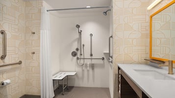 A modern bathroom with a shower, toilet, and sink.