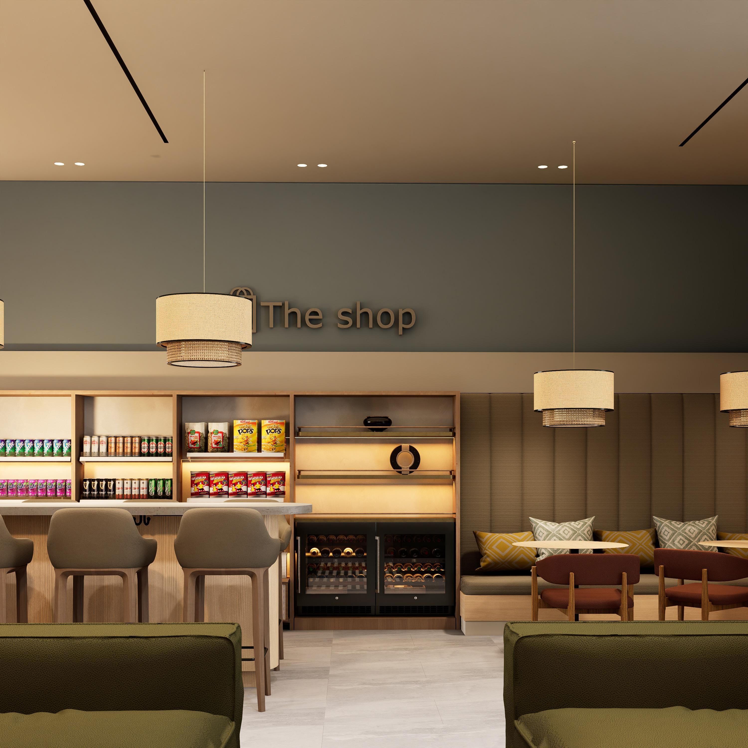 Un interior moderno con una zona de bar, asientos y un letrero que dice 'The shop'.