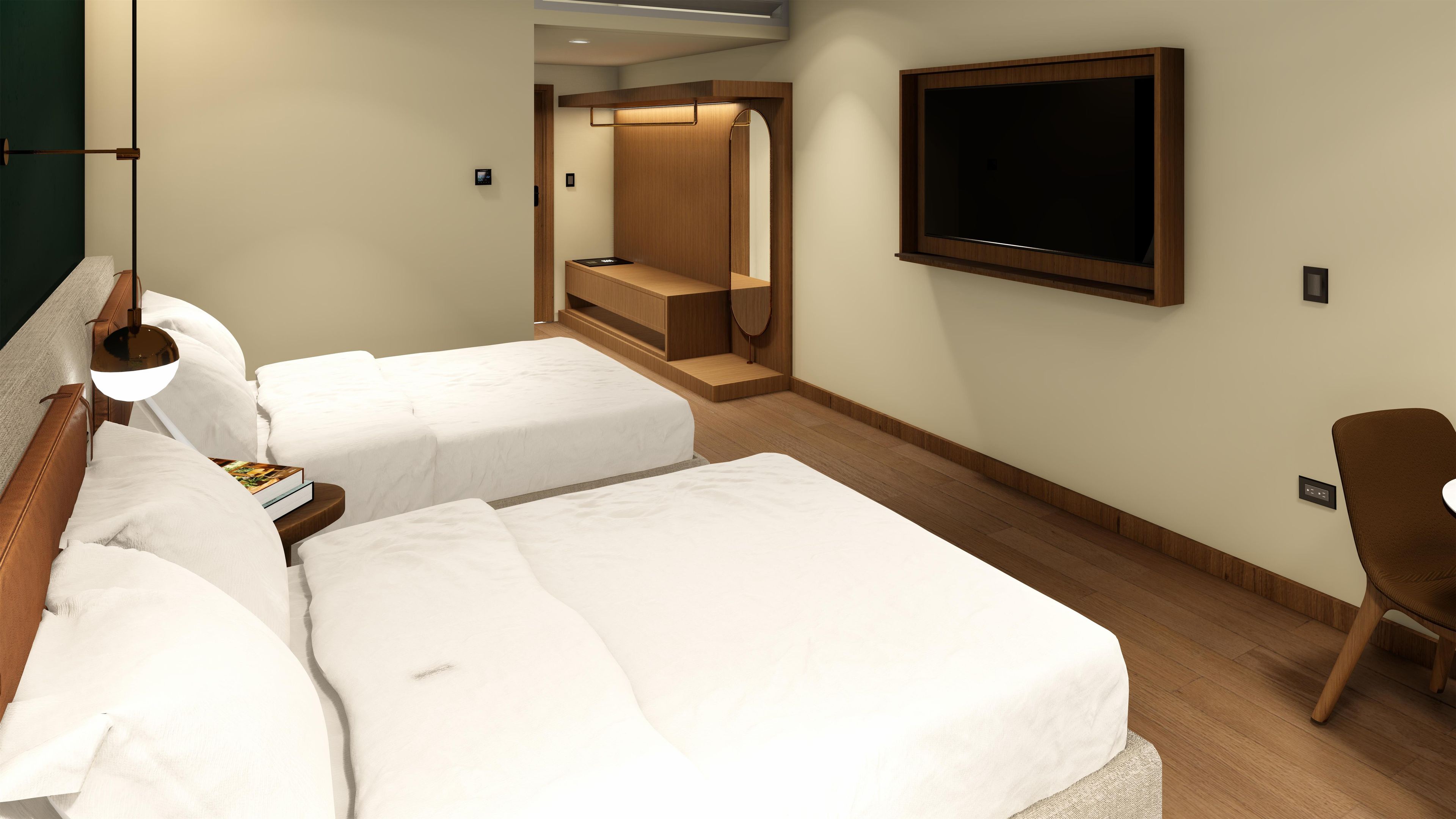 A hotel room with two beds, a TV, a desk, and a chair.