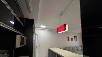 Deluxe Apartment | Private kitchen | Fridge, microwave, cookware/dishes/utensils, dining tables