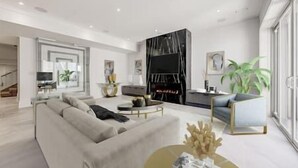 A modern living room with a sofa, coffee table, and a TV. There is a staircase leading to another level. - Mansion Newly Built Custom Design Never Lived In! (Toronto)