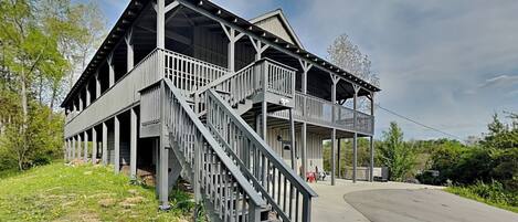 A two-story building with a balcony and a staircase.