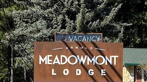 A sign for Meadowmont Lodge with a lion sculpture. - Comfortable Lodge Room 13 with Extra Amenities (2 doubles, pet-friendly) (Arnold)