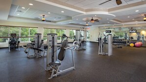 Een sportschool met cardioapparatuur, losse gewichten en fitnessballen.