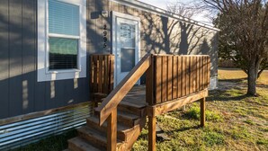 A single-story house with a front porch, a mailbox, and a number '2995' on the door. - Joy Drive In Movie & RV Resort - 2995 Barr Ln - Relaxing 3BR/2BA Getaway (Copperas Cove)