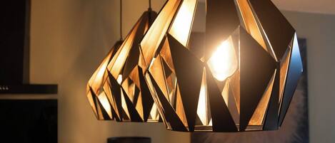 A geometric pendant light fixture with multiple panels.