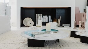 A modern living room with a fireplace, round coffee tables, and a white sofa. - Villa Zabbara, independent and private pool (CASTELLAMMARE DEL GOLFO)
