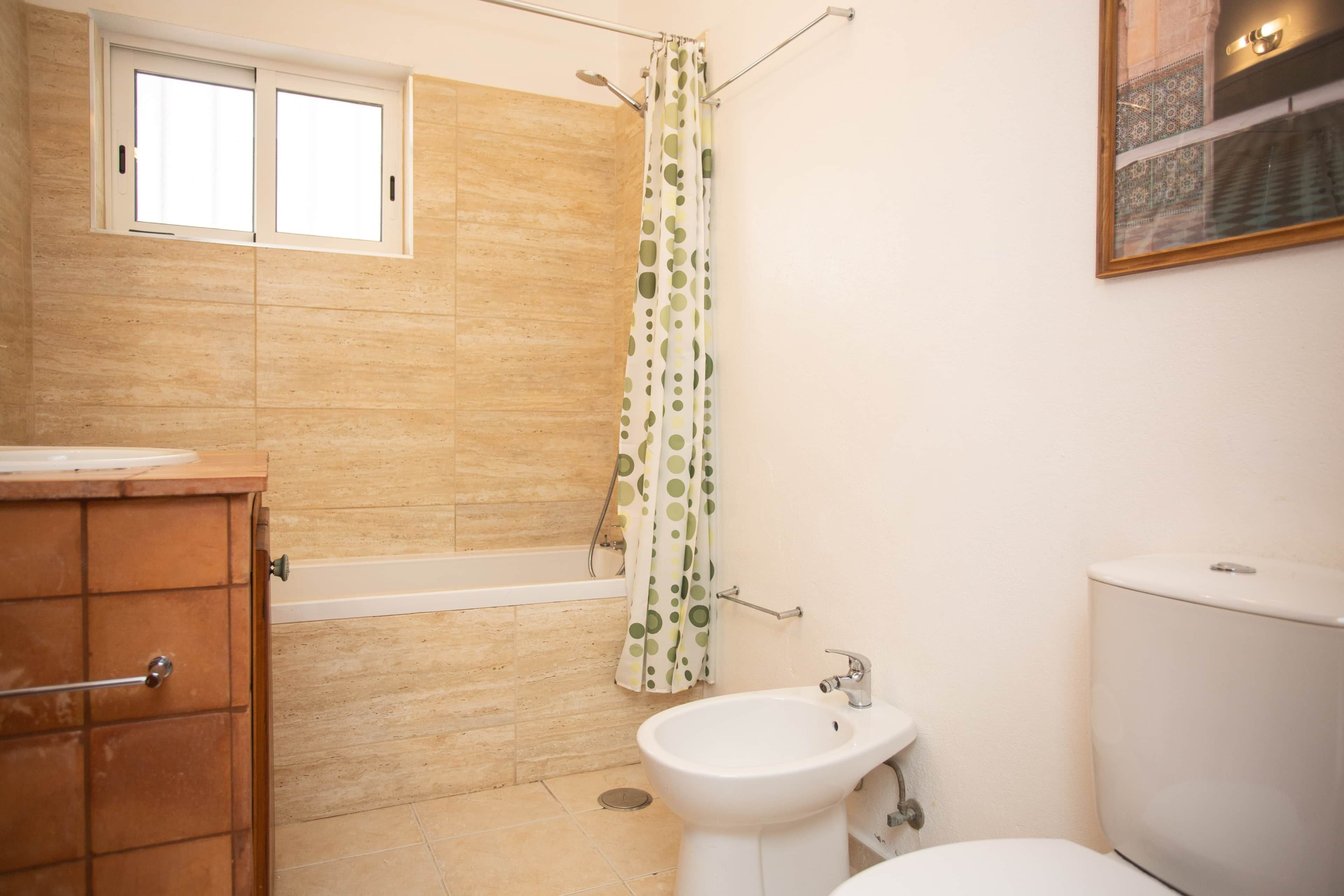 A bathroom with a bathtub, a sink, and a toilet.