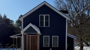 A two-story house with a front porch and a garage.