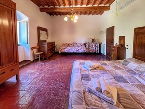 A bedroom with a large bed, wooden furniture, a dresser, and a mirror. - Un Angolo nel Borgo - Two Bedroom Apartment, Sleeps 7 (Camucia)