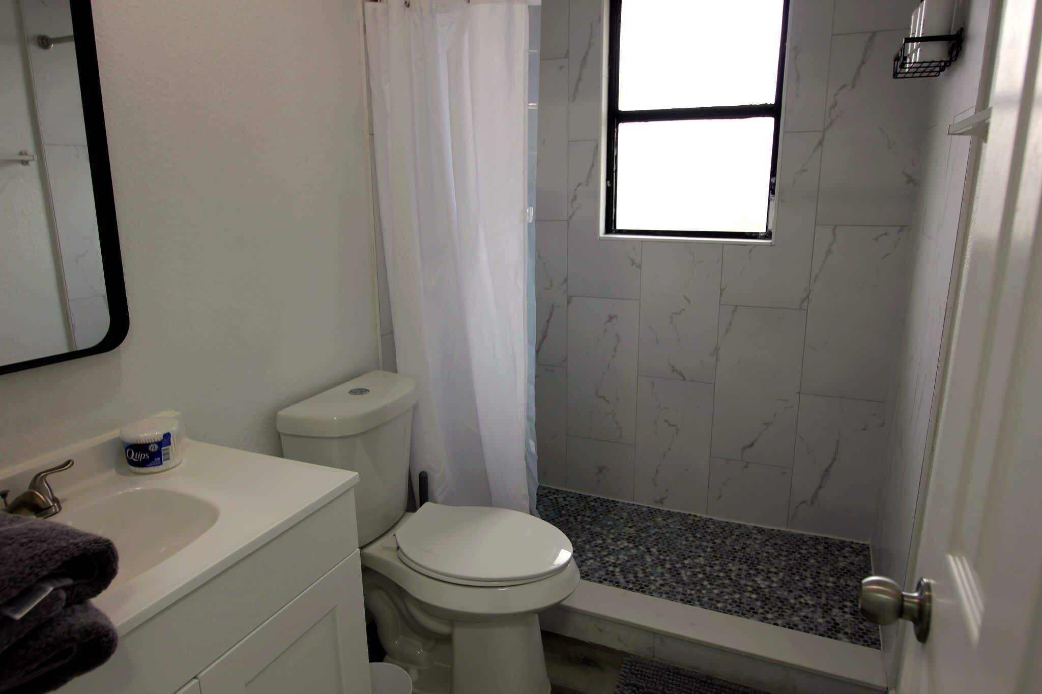 Shower, hair dryer, towels, shampoo