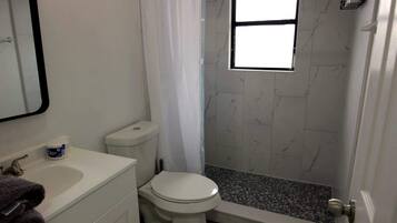 Shower, hair dryer, towels, shampoo