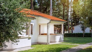 A small, single-story house with a tiled roof, white exterior walls, and a covered porch. - Gorgeous apartment in Porec with WiFi (Porec)